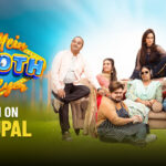 Punjabi comedy movie "Ki Mein Jhooth Boleya" featuring an ensemble cast seated around a sofa in an outdoor setting. The characters display a mix of humorous, confused, and serious expressions, hinting at family drama and comedy.